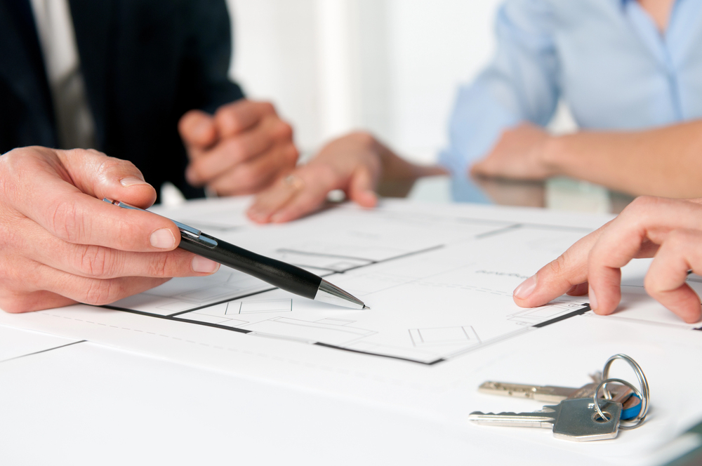 People in an office setting signing a housing contract